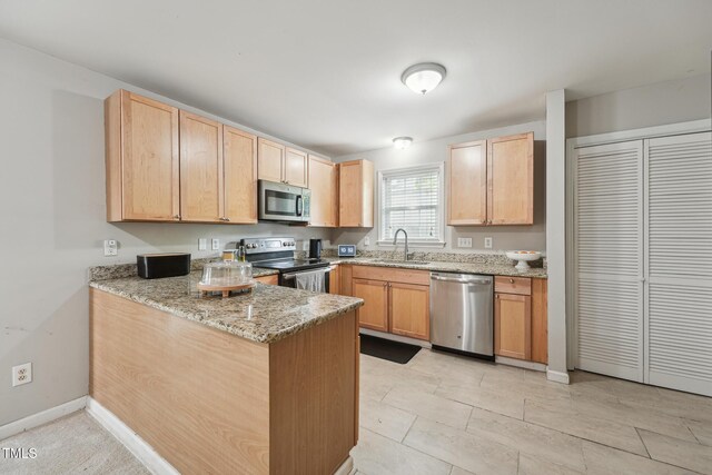 2028 Ruddy Rd, Raleigh, NC 27616 - kitchen featuring light brown cabinetry, a sink, a peninsula, and stainless steel appliances