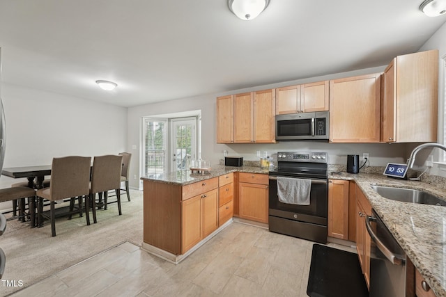 2028 Ruddy Rd, Raleigh, NC 27616 - kitchen with appliances with stainless steel finishes, a peninsula, light stone countertops, and a sink