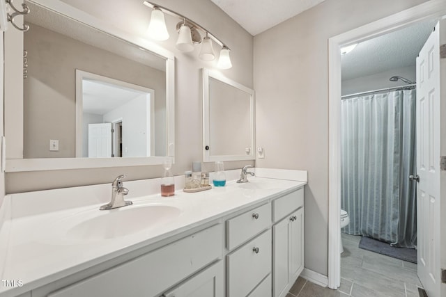 2028 Ruddy Rd, Raleigh, NC 27616 - bathroom featuring curtained shower, toilet, double vanity, and a sink