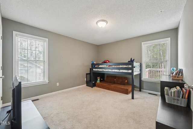 2028 Ruddy Rd, Raleigh, NC 27616 - carpeted bedroom featuring a textured ceiling and baseboards