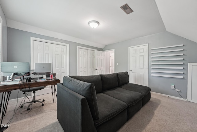 2028 Ruddy Rd, Raleigh, NC 27616 - living area with visible vents, baseboards, vaulted ceiling, and carpet floors