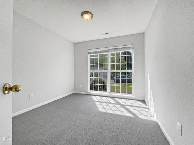 107 Kinship Ln, Apex, NC 27502 - carpeted spare room with baseboards, visible vents, and a textured ceiling