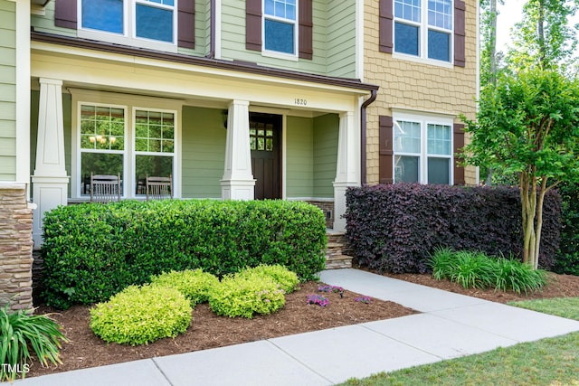 view of exterior entry with a porch