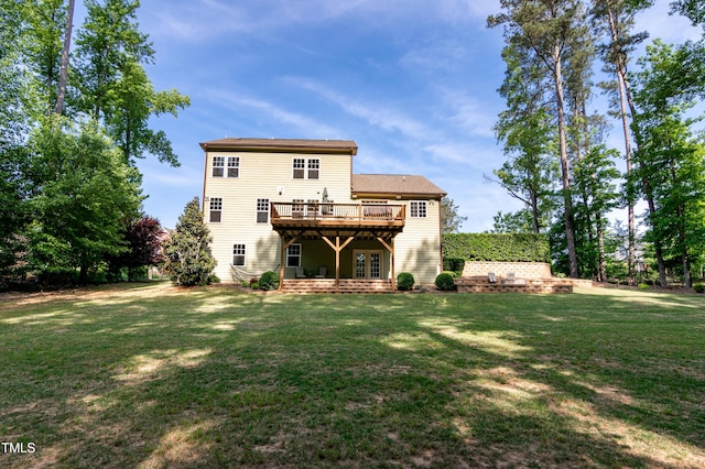 back of property with french doors, a lawn, and a deck
