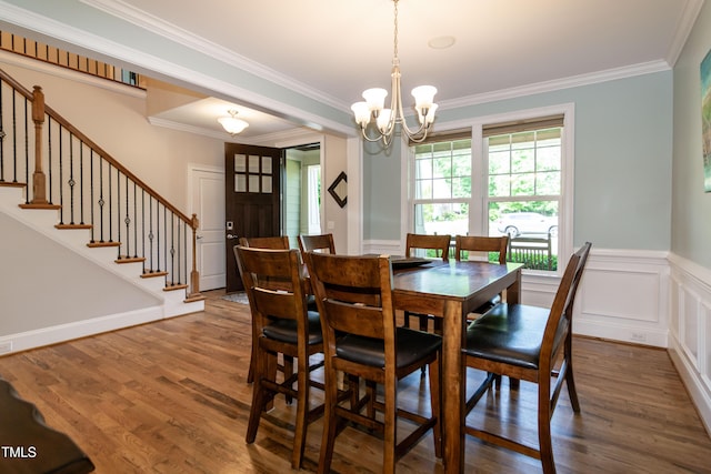 dining area with crown molding, dark wood finished floors, stairs, and a chandelier
