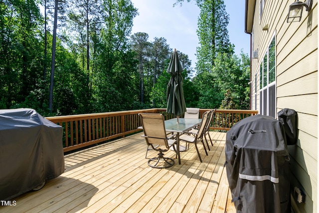 wooden deck with grilling area and outdoor dining area