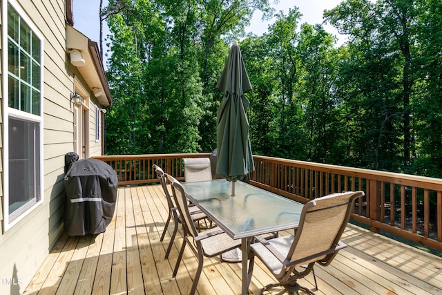wooden terrace featuring outdoor dining area and area for grilling