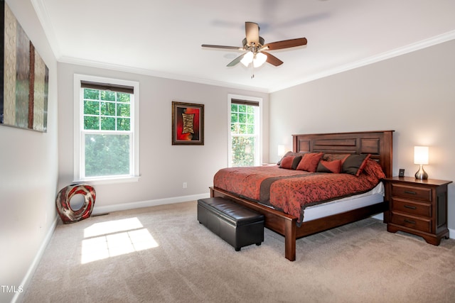 bedroom featuring light colored carpet, ornamental molding, baseboards, and a ceiling fan