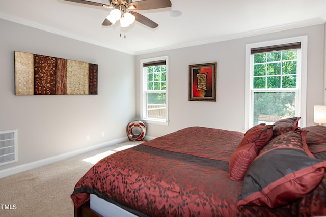 carpeted bedroom featuring crown molding, baseboards, and visible vents