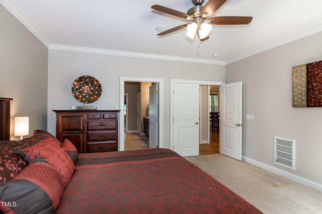 bedroom with visible vents, baseboards, crown molding, and light carpet