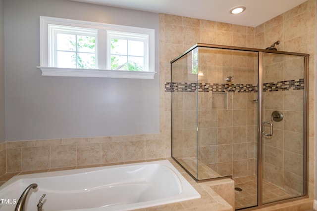 bathroom with recessed lighting, a garden tub, and a stall shower