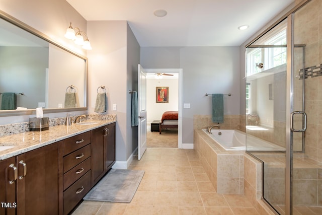 bathroom featuring double vanity, a bath, tile patterned floors, and a stall shower