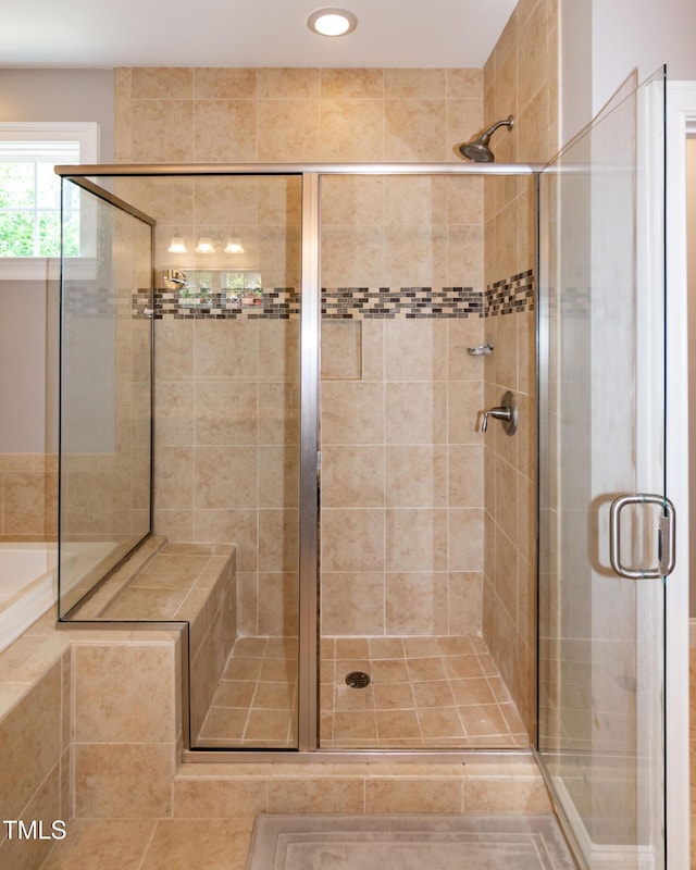 full bathroom featuring recessed lighting and a shower stall