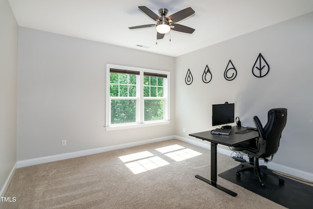 carpeted home office featuring visible vents, a ceiling fan, and baseboards
