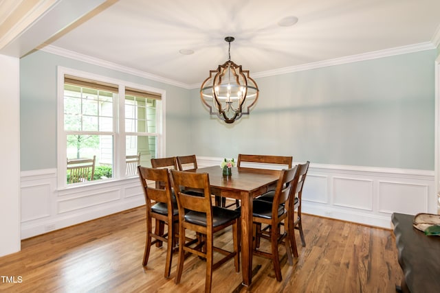 1820 Yates Wheel Way, Raleigh, NC 27606 - dining space with a chandelier, wood finished floors, a wainscoted wall, and crown molding