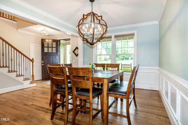 1820 Yates Wheel Way, Raleigh, NC 27606 - dining space with a chandelier, wood finished floors, crown molding, stairs, and wainscoting