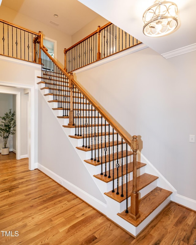 1820 Yates Wheel Way, Raleigh, NC 27606 - staircase featuring wood finished floors, baseboards, and a chandelier