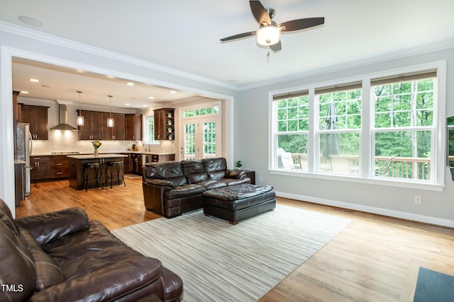 1820 Yates Wheel Way, Raleigh, NC 27606 - living area with light wood-type flooring, ceiling fan, crown molding, and baseboards
