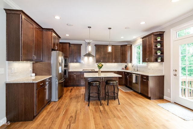 1820 Yates Wheel Way, Raleigh, NC 27606 - kitchen with stainless steel appliances, open shelves, dark brown cabinets, ornamental molding, and wall chimney range hood