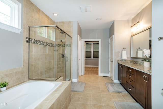 1820 Yates Wheel Way, Raleigh, NC 27606 - bathroom with a shower stall, a bath, vanity, tile patterned floors, and baseboards