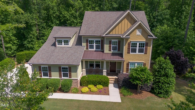 1820 Yates Wheel Way, Raleigh, NC 27606 - craftsman house with covered porch, board and batten siding, a shingled roof, and a front lawn