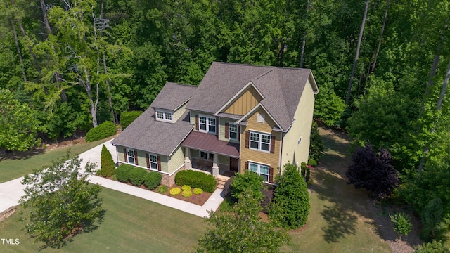 1820 Yates Wheel Way, Raleigh, NC 27606 - view of front of property featuring a standing seam roof, a porch, a shingled roof, concrete driveway, and metal roof