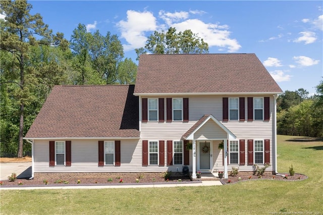 119 Woodbine Dr, Raeford, NC 28376 - colonial house with a front yard and roof with shingles