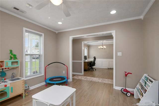 119 Woodbine Dr, Raeford, NC 28376 - rec room with light wood-style floors, a sink, healthy amount of natural light, ornamental molding, and a ceiling fan