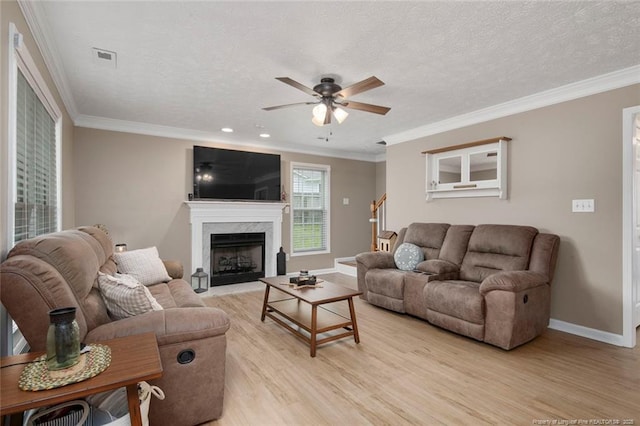119 Woodbine Dr, Raeford, NC 28376 - living area featuring light wood-type flooring, ceiling fan, baseboards, ornamental molding, and a fireplace