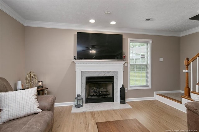 119 Woodbine Dr, Raeford, NC 28376 - living room with wood finished floors, a high end fireplace, crown molding, baseboards, and stairway
