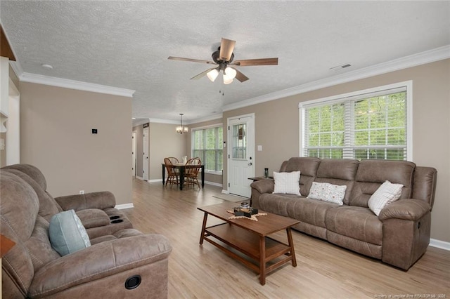 119 Woodbine Dr, Raeford, NC 28376 - living room featuring a ceiling fan, light wood finished floors, crown molding, baseboards, and a chandelier