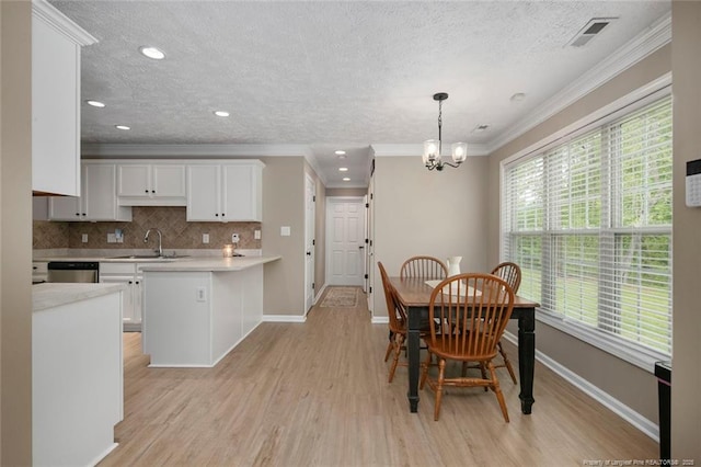 119 Woodbine Dr, Raeford, NC 28376 - dining space with crown molding, a chandelier, light wood-style floors, baseboards, and a textured ceiling