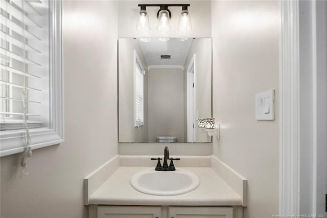 119 Woodbine Dr, Raeford, NC 28376 - bathroom featuring vanity and ornamental molding