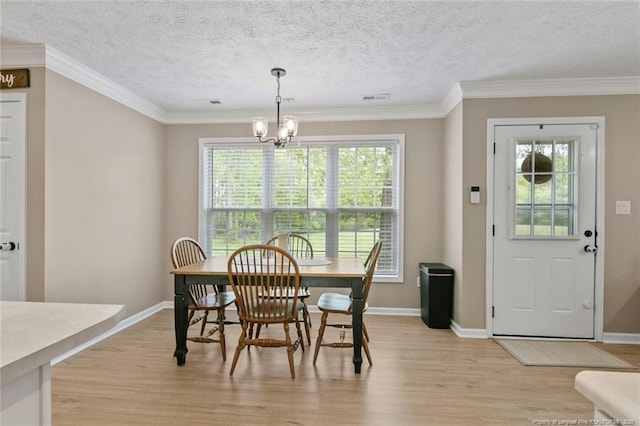 119 Woodbine Dr, Raeford, NC 28376 - dining room featuring light wood finished floors, a chandelier, baseboards, ornamental molding, and a textured ceiling