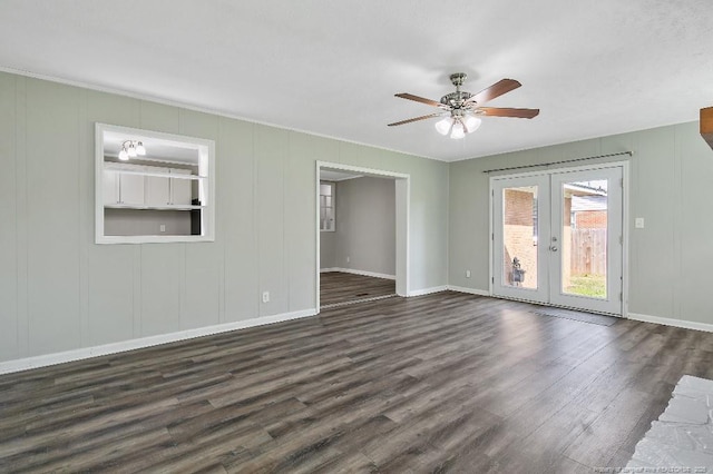 unfurnished living room with french doors, baseboards, a ceiling fan, a decorative wall, and dark wood-type flooring