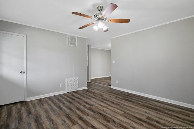 spare room featuring a ceiling fan, ornamental molding, dark wood-style floors, and visible vents