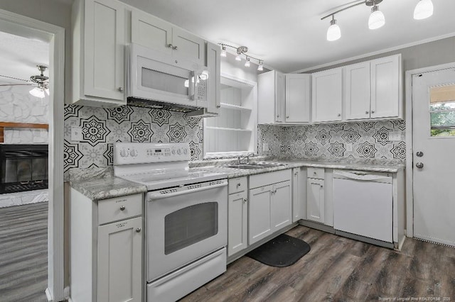 kitchen featuring white cabinets, tasteful backsplash, a sink, and white appliances