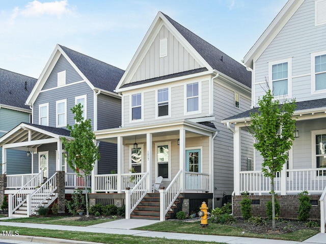 view of front facade featuring board and batten siding, a porch, and a shingled roof