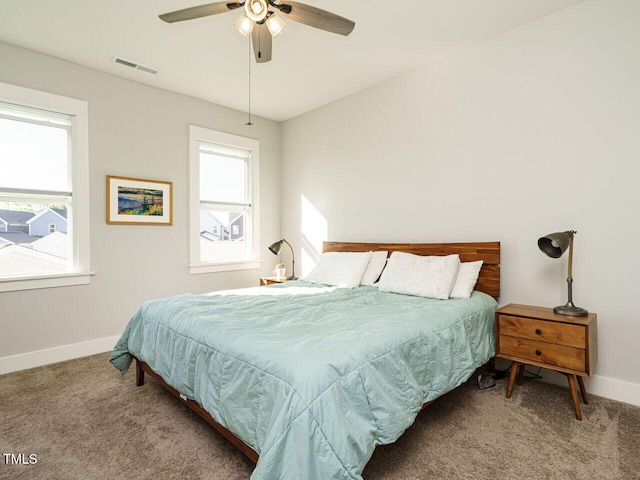 bedroom featuring visible vents, carpet flooring, and multiple windows