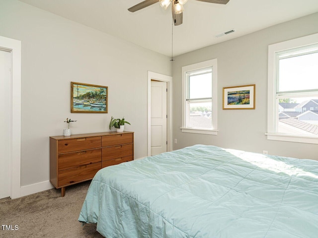 bedroom featuring carpet, visible vents, baseboards, and ceiling fan