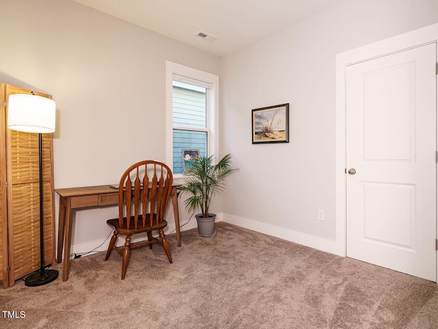 carpeted office featuring visible vents and baseboards