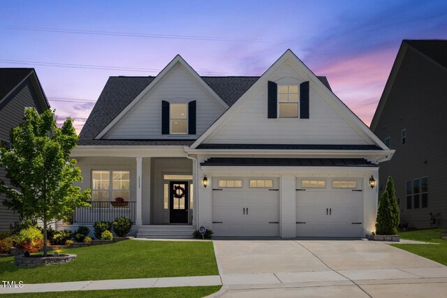 1513 Armscroft Ln, Apex, NC 27502 - view of front of house featuring a porch, roof with shingles, a garage, a front lawn, and concrete driveway