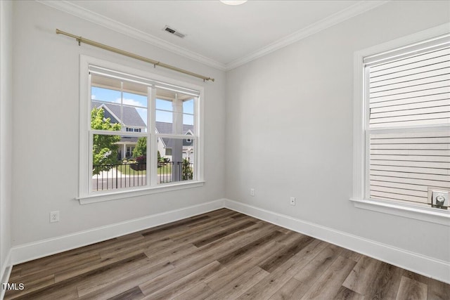 1513 Armscroft Ln, Apex, NC 27502 - empty room with baseboards, crown molding, wood finished floors, and visible vents