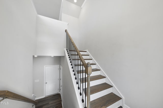 stairway featuring wood finished floors and baseboards