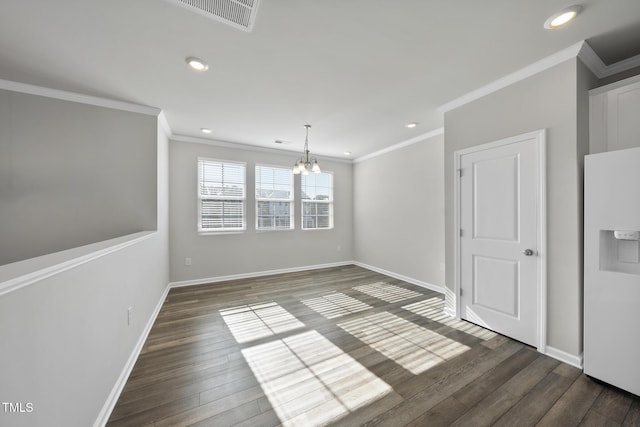 unfurnished dining area featuring visible vents, a notable chandelier, ornamental molding, and dark wood finished floors