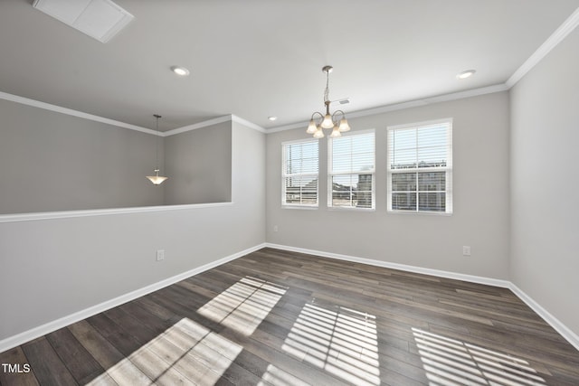 spare room with an inviting chandelier, ornamental molding, wood finished floors, and baseboards