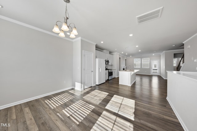unfurnished living room with a chandelier, visible vents, crown molding, and baseboards