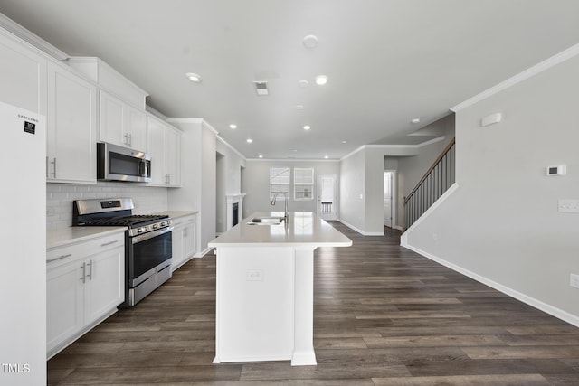 kitchen with a sink, an island with sink, stainless steel appliances, visible vents, and recessed lighting