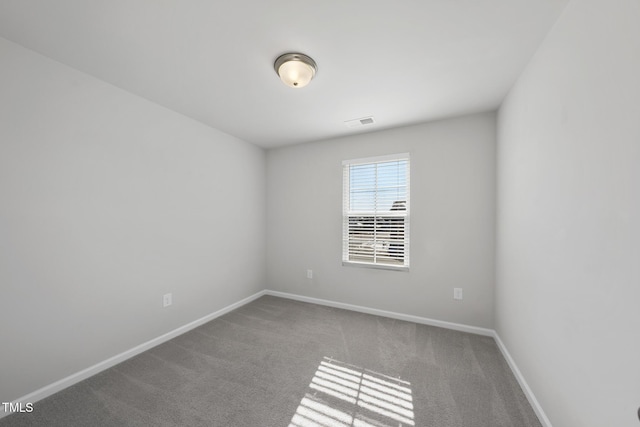 carpeted spare room featuring baseboards and visible vents