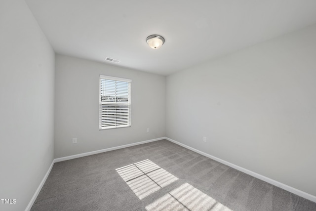 carpeted empty room with baseboards and visible vents